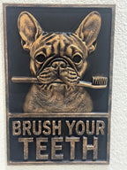 Front view of black and antique gold Brush Your Teeth plaque with a French Bulldog holding a toothbrush