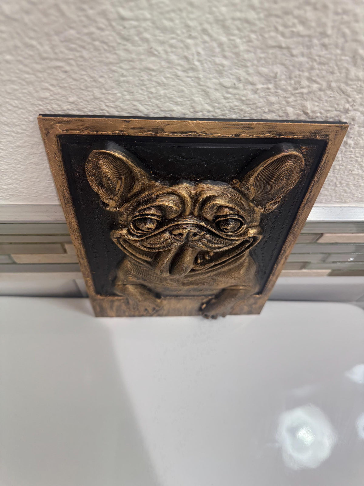 Top-down view of the Frenchie plaque showing ears and wrinkles