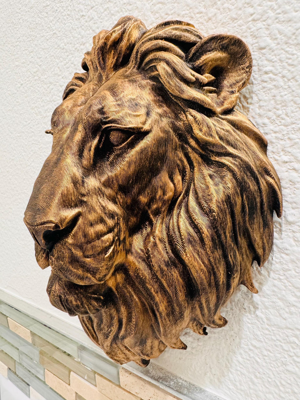 Left side profile of the lion head sculpture showing depth