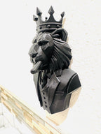 Left angle of the black low-poly lion in a suit and crown smoking a cigar