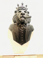 Low front view of the black crowned lion wall sculpture with vest and cigar