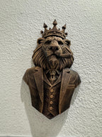 Front view of the crowned lion boss bust on a textured wall