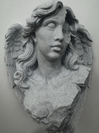 Close front view of the angel's cracked face and wavy hair