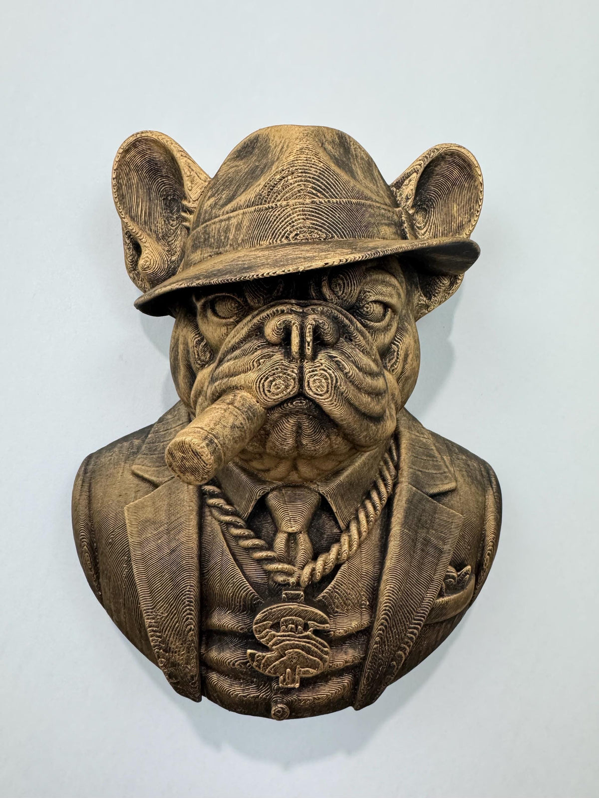 Front view of antique gold French Bulldog mob boss bust in a fedora with a cigar and chain
