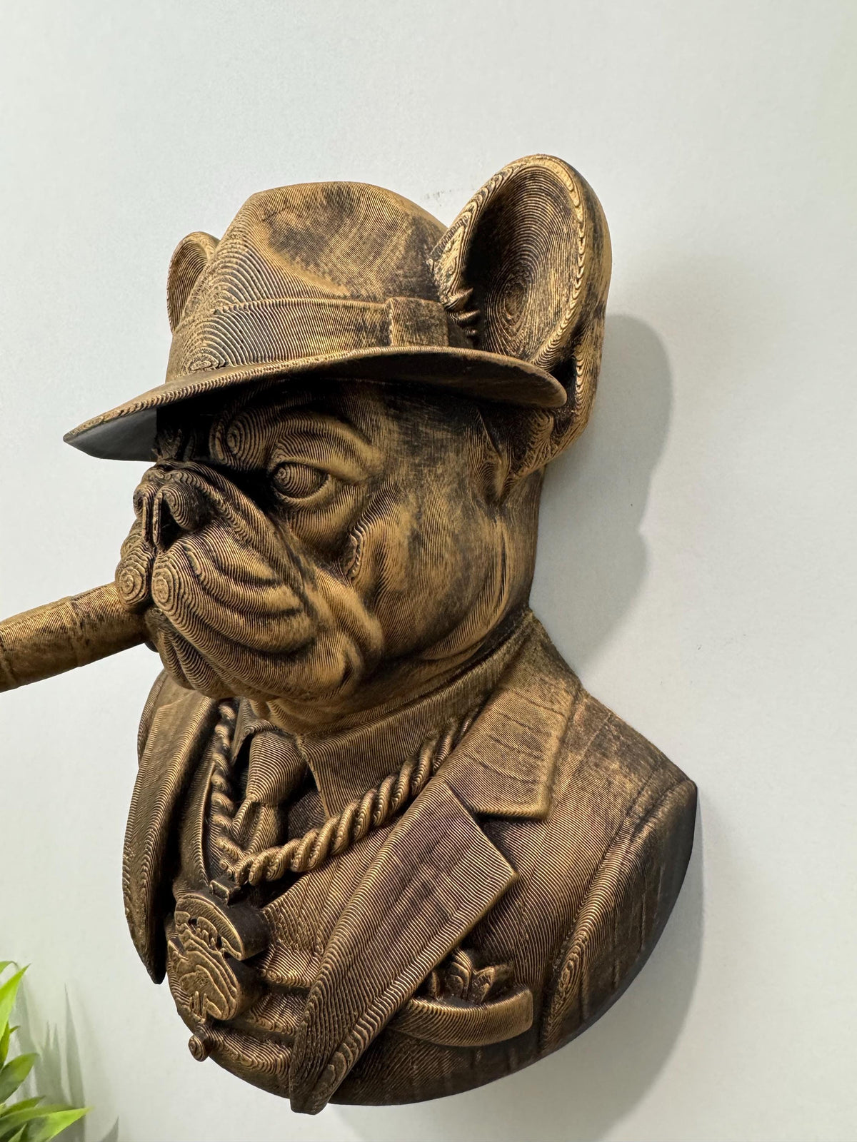 Left side profile of the bulldog boss with cigar and fedora