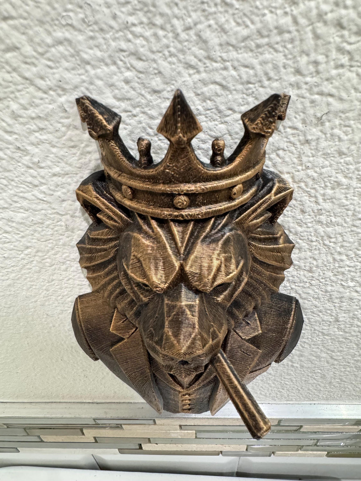 Low angle of the crowned lion boss showing crown points and cigar