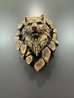 Close front view of the gold wolf's face and fur inside the broken stone ring