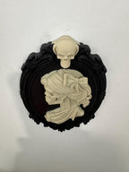 Low angle of the skeleton cameo showing the raised skull on the frame