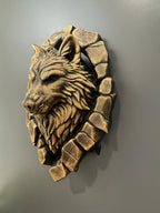 Left side profile of the gold wolf emerging from the stone wall