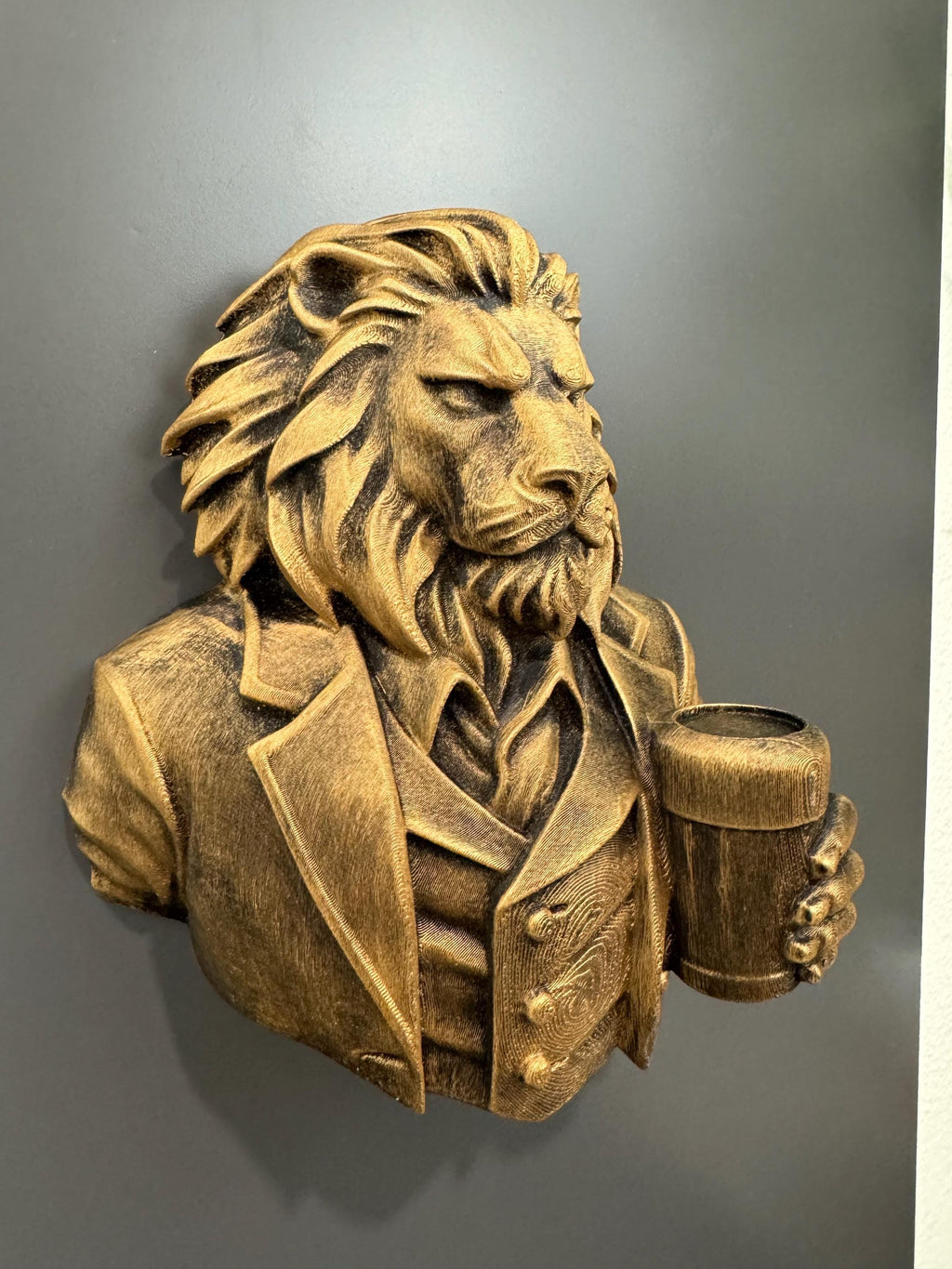 Right angle of the gold lion gentleman showing mane and vest