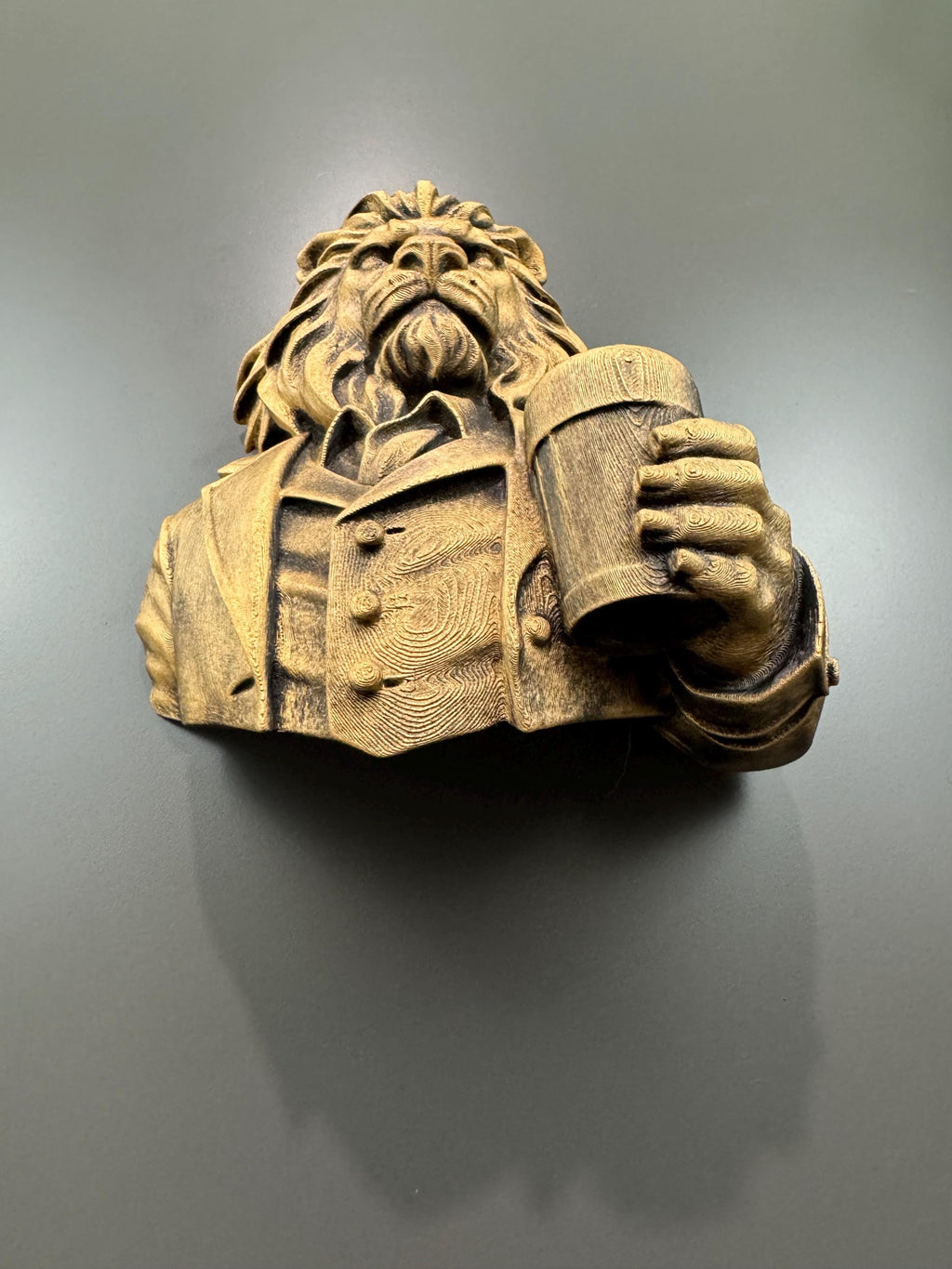 Top-down view of the lion bust holding a pint glass