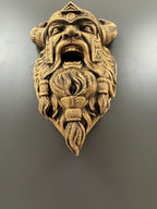 Low angle of the roaring Viking sculpture showing open mouth and beard braids
