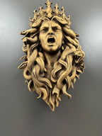 Close front view of Medusa's open-mouthed battle cry framed by snakes