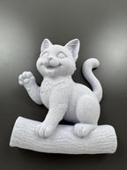 Low angle of the happy kitten sculpture showing the log base depth