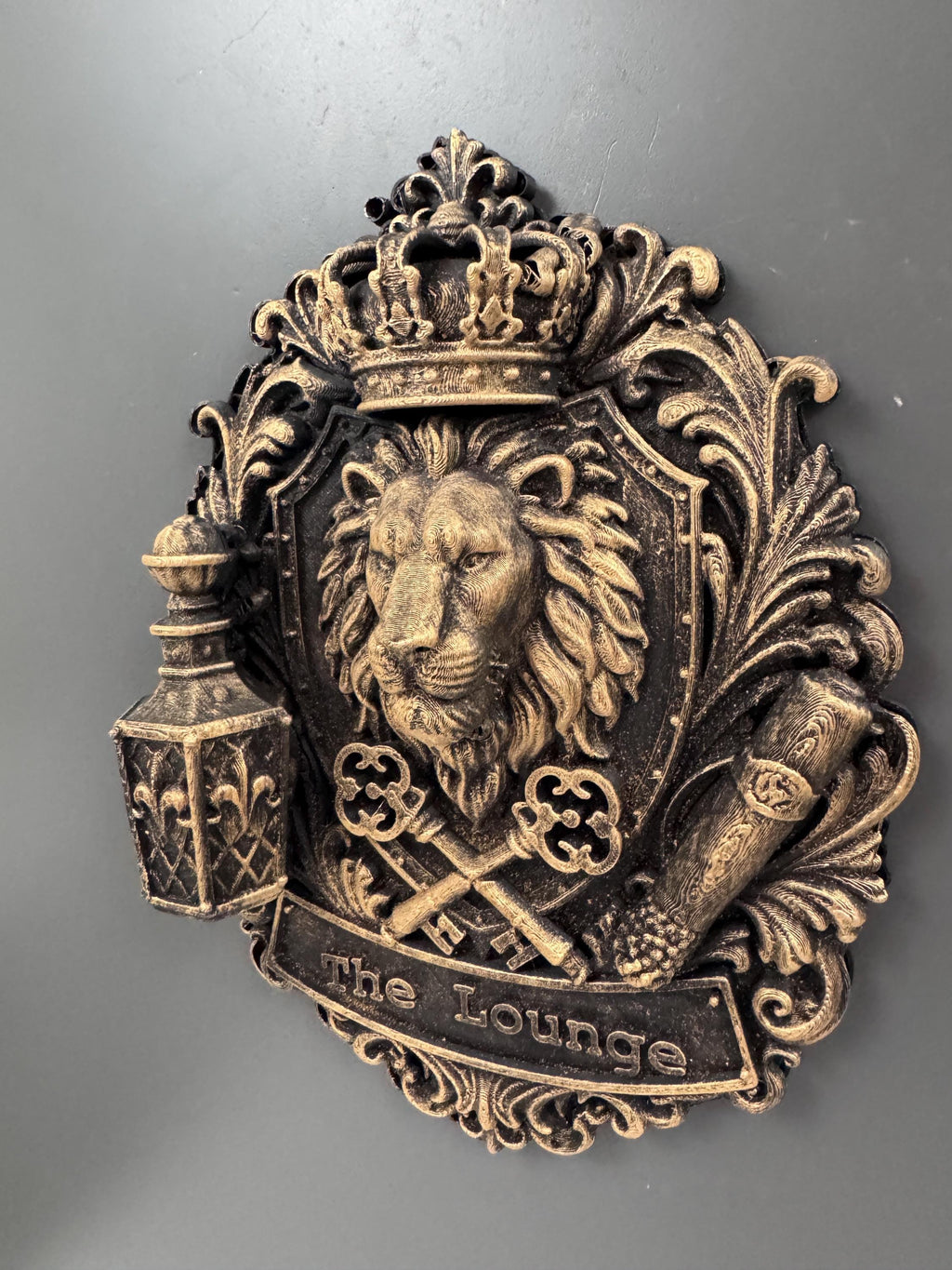 Left angle of The Lounge plaque showing lantern and banner depth