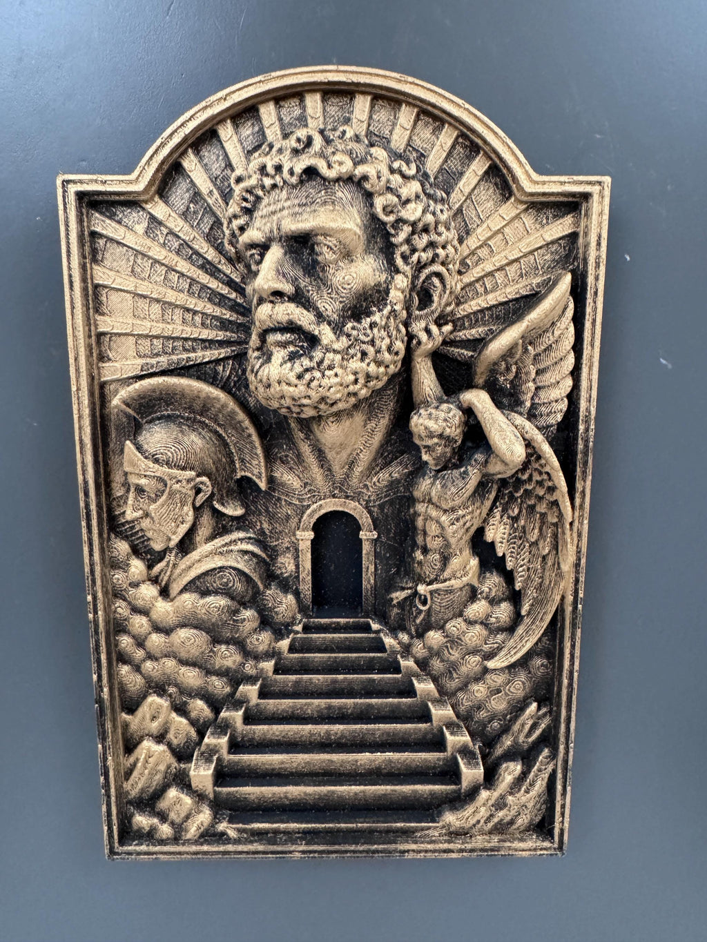 Front view of the Gates of Heaven plaque on a gray wall
