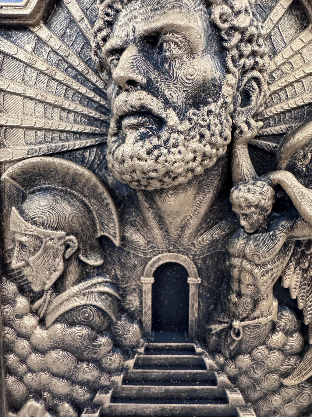 Close-up of the bearded saint and stairway on the Gates of Heaven plaque