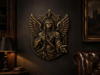 Saint Michael sculpture on a dark wall above a leather chair and lamp