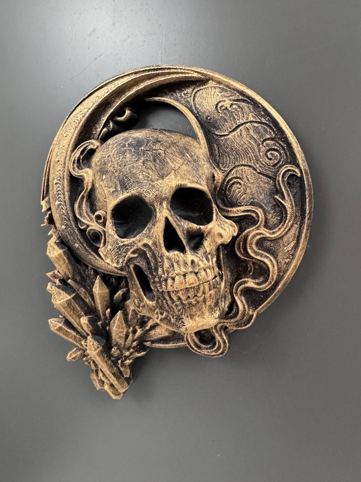 Front view of the moon skull sculpture with smoke swirls