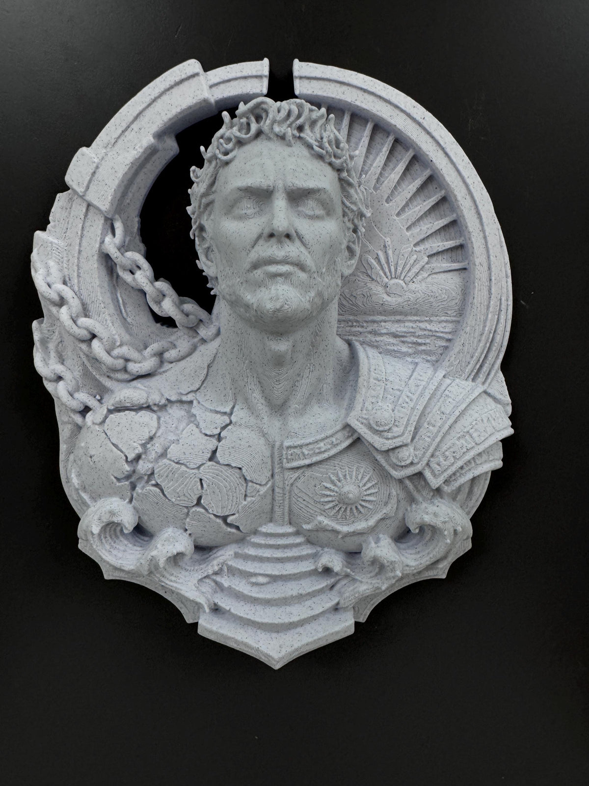 Front view of the Prometheus relief with laurel crown and falling chains