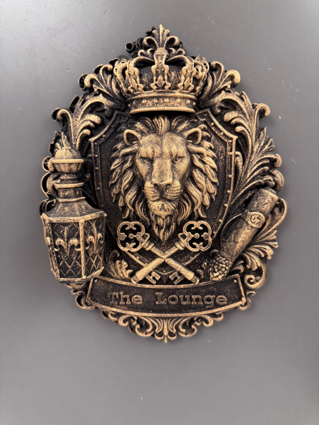 Front view of the gold lion crest with crossed keys and scroll