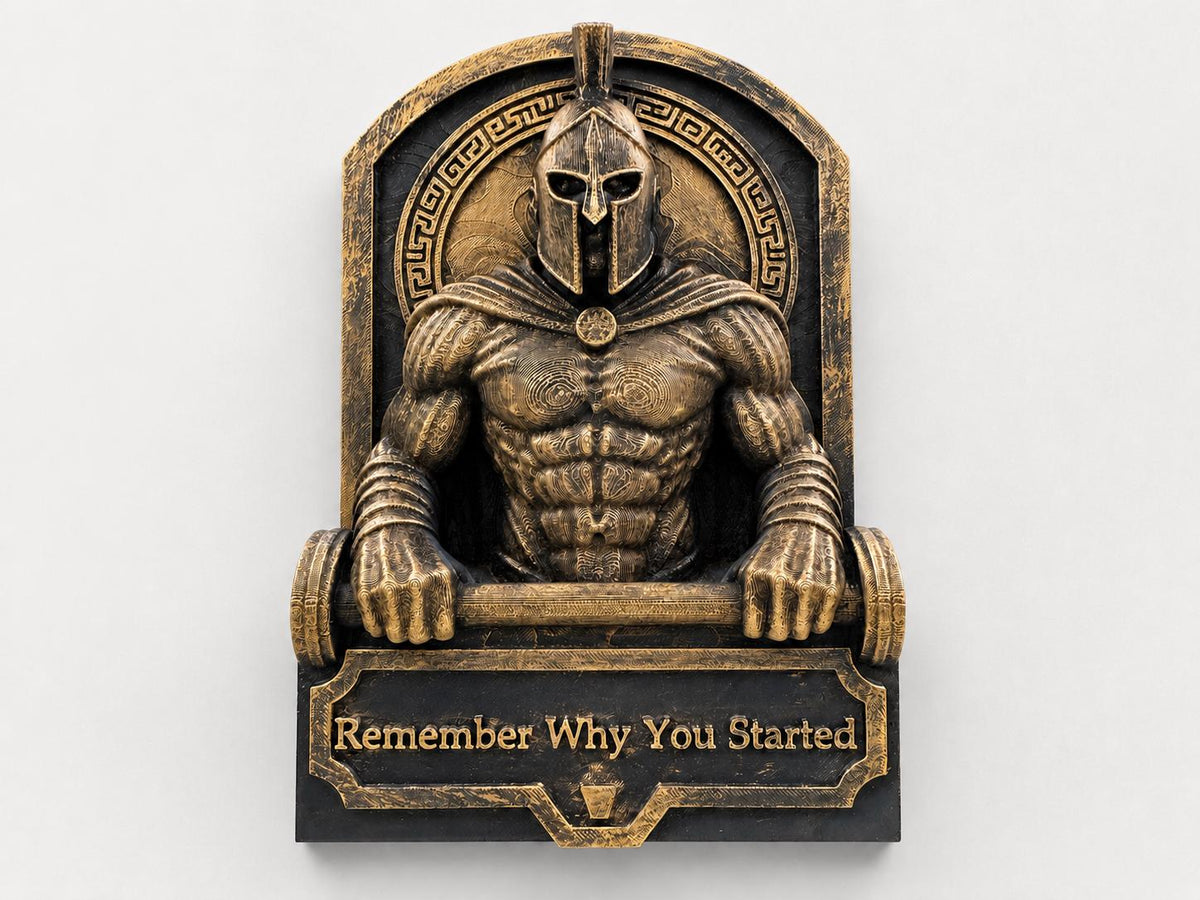 Front view of antique gold Spartan gym sculpture gripping a barbell above Remember Why You Started