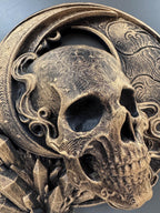Close-up of the gold skull's eye sockets, teeth and etched stars
