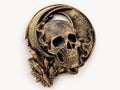 Angled view of antique gold skull cradled in a crescent moon with crystal points