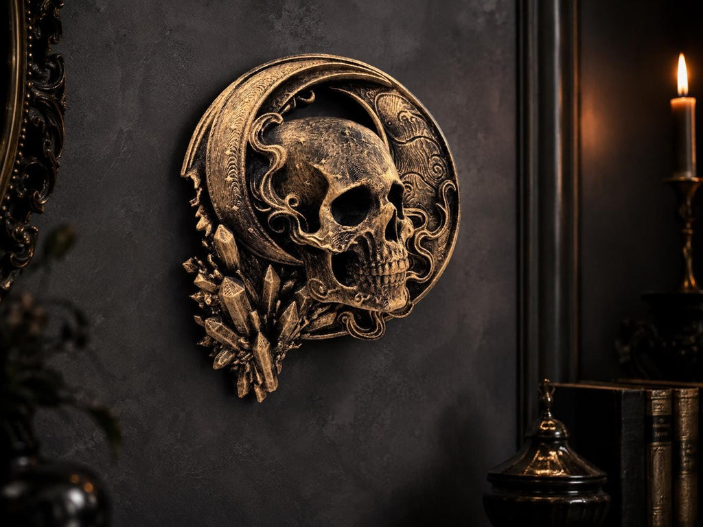 Crescent moon skull sculpture on a dark wall beside a candle