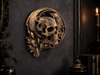 Crescent moon skull sculpture on a dark wall beside a candle