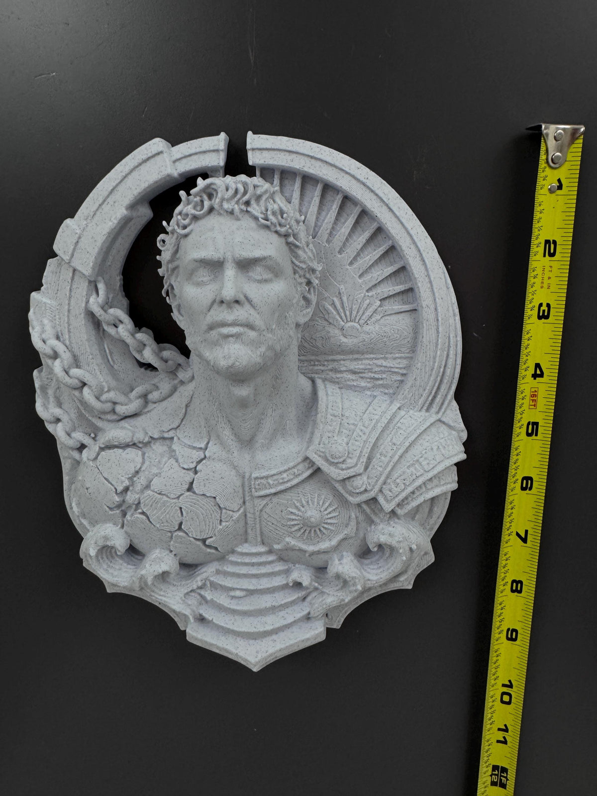Prometheus wall sculpture beside a tape measure showing its height