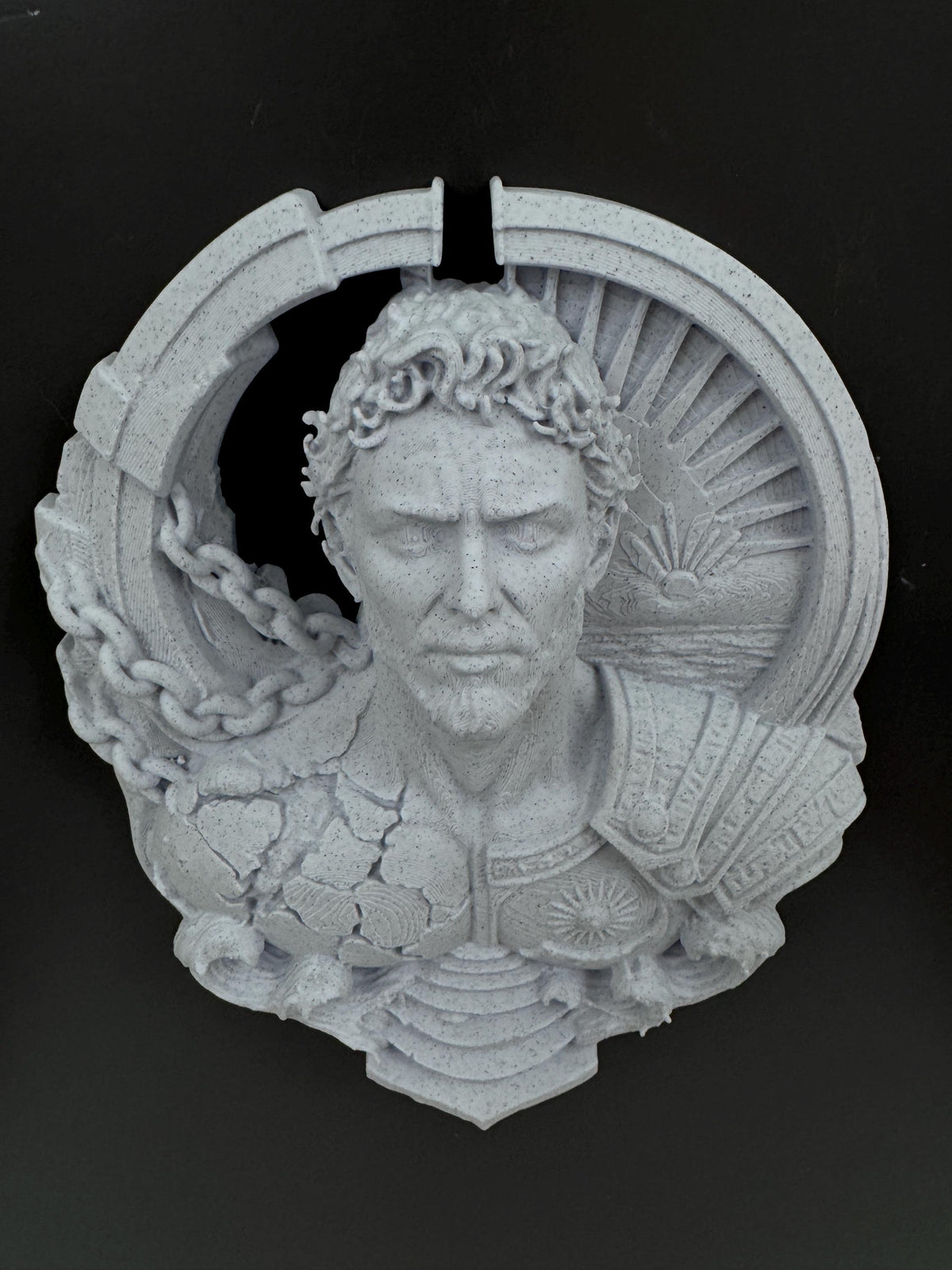 Close front view of Prometheus's stern face and laurel crown