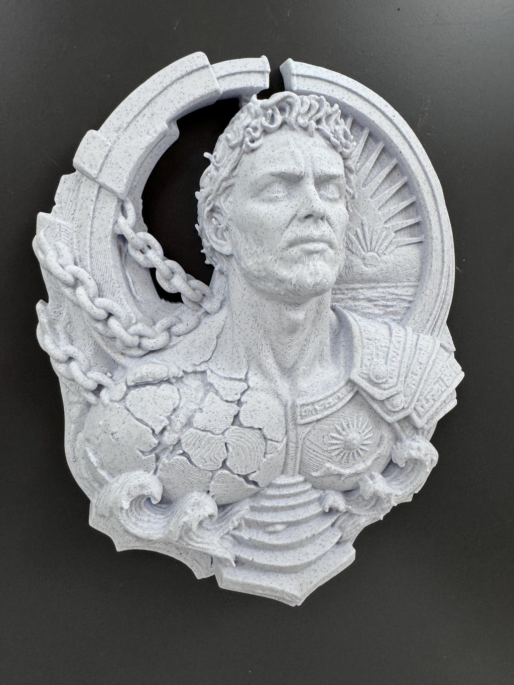 Right angle of the Prometheus sculpture showing the sunburst and waves