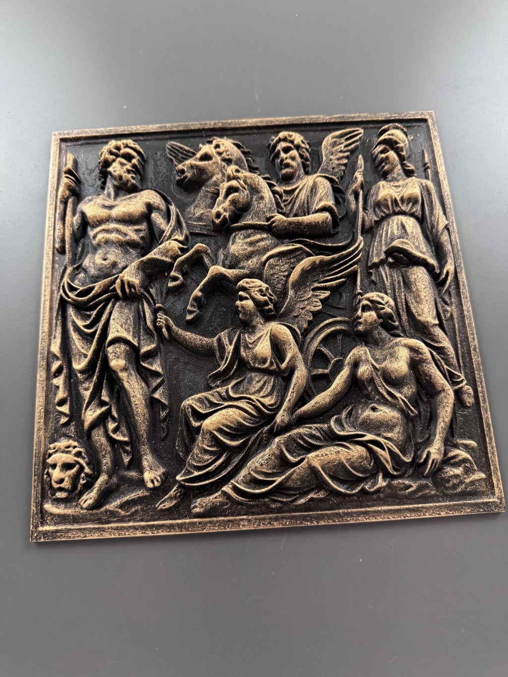 Slight angle of the antique gold Olympian relief panel
