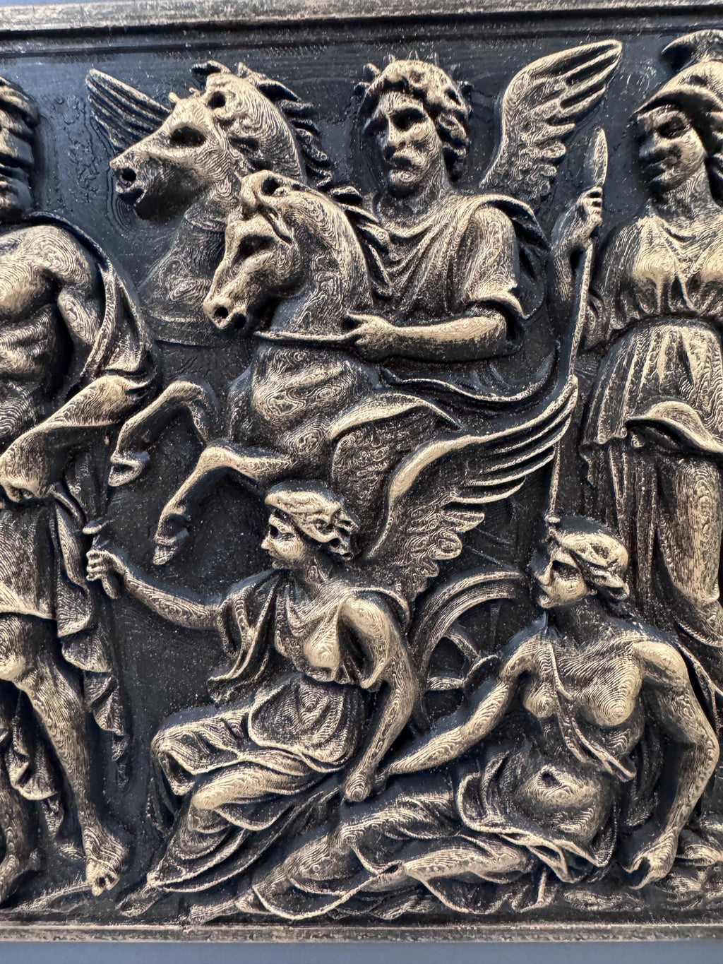 Close-up of Pegasus, the winged figures and Athena's helmet