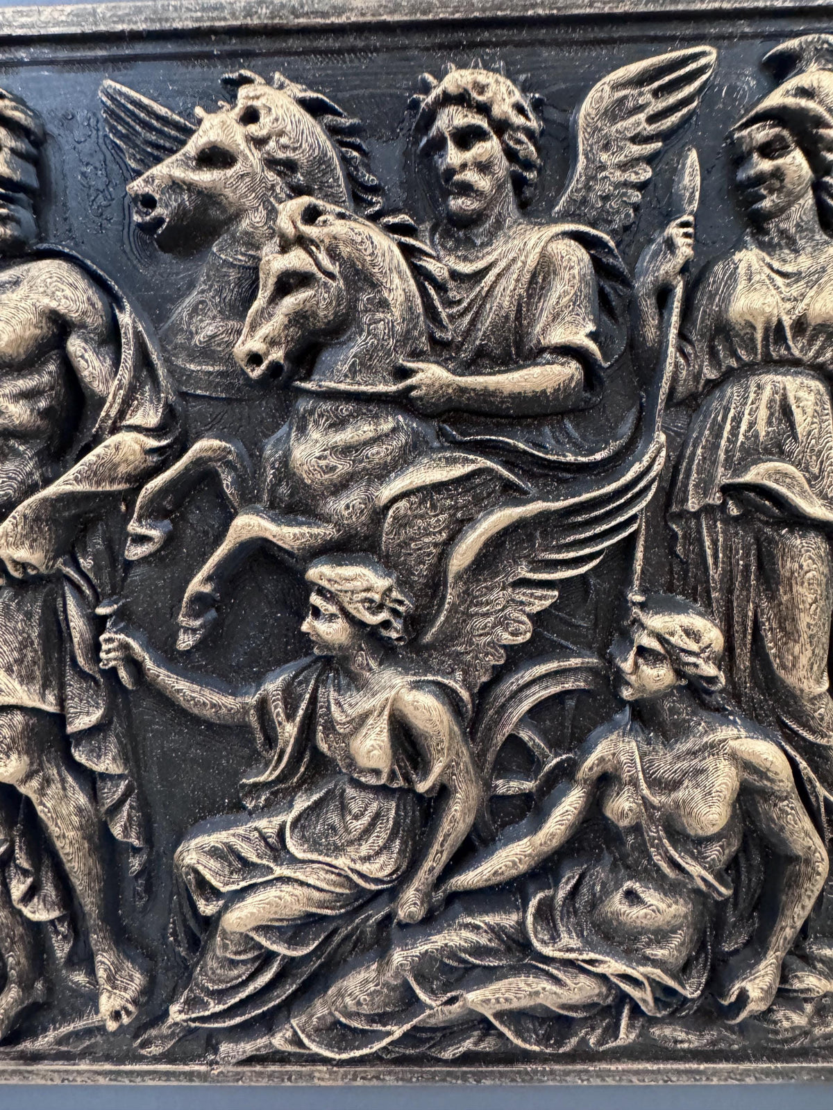 Close-up of Pegasus, the winged figures and Athena's helmet