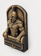 Left angle of the gold Spartan sculpture showing helmet crest