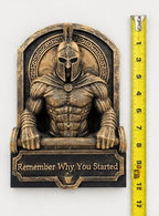 Spartan sculpture beside a tape measure showing its height