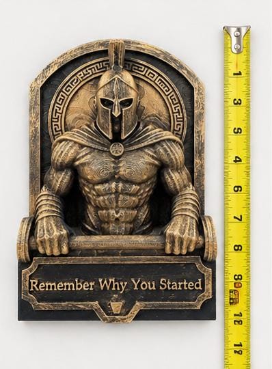 Spartan sculpture beside a tape measure showing its height