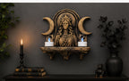 Hecate altar shelf on a dark wall holding two LED tealights beside a candlestick