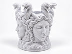 Left angle of the Medusa holder showing a second face and coiled snakes