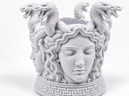 Close front view of the Medusa face and Greek key base