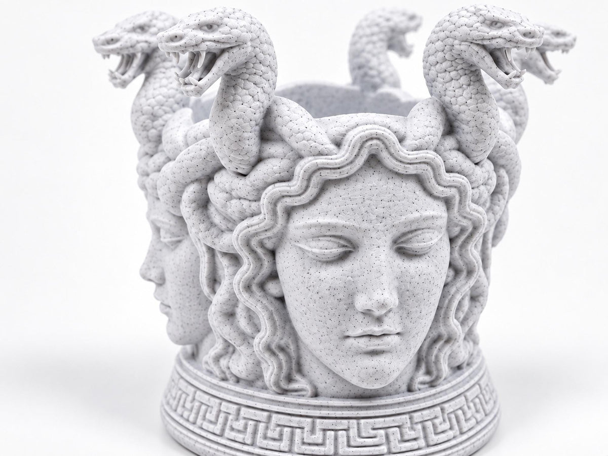 Close front view of the Medusa face and Greek key base