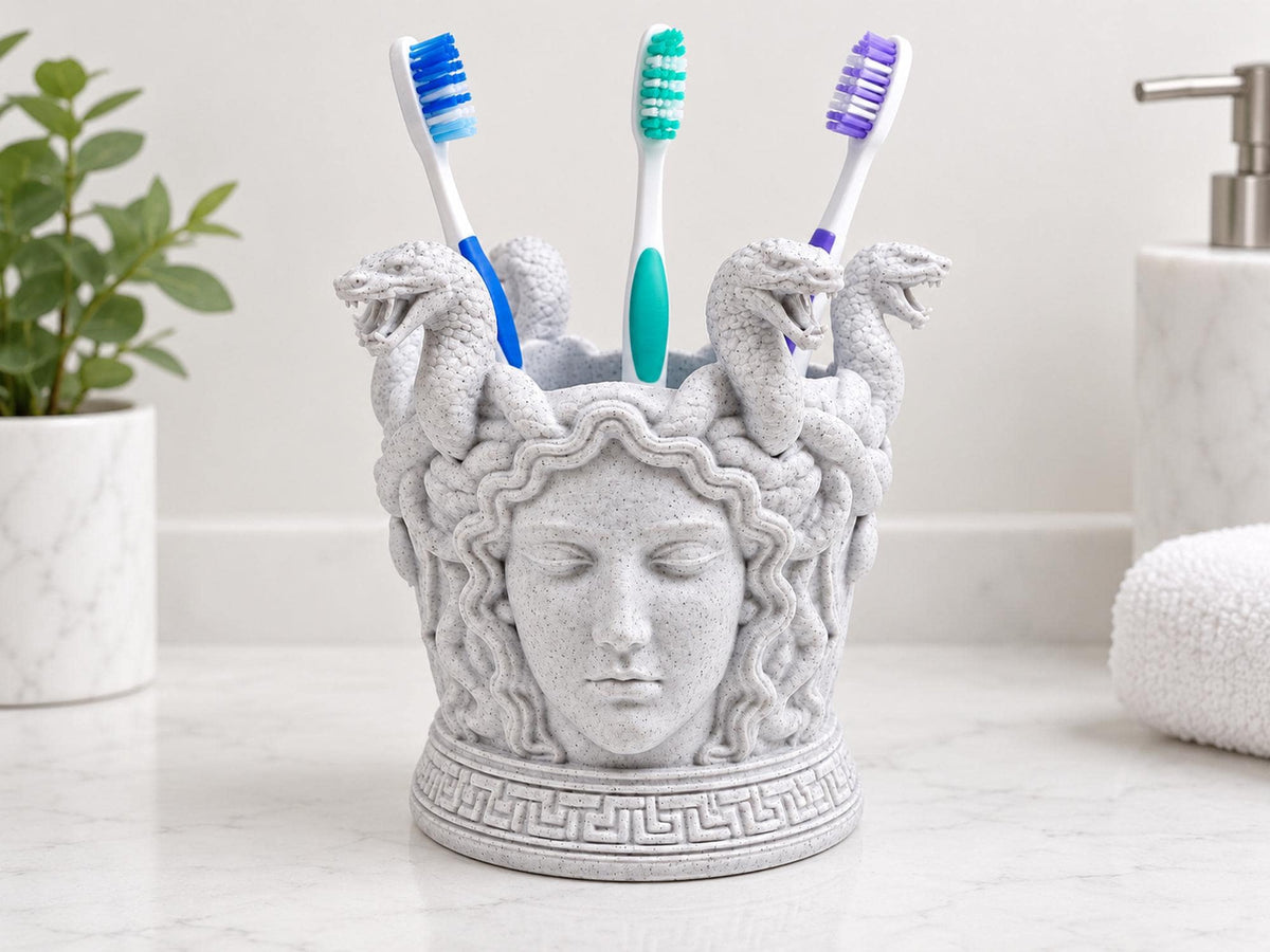 Speckled white Medusa toothbrush holder on a bathroom counter with three toothbrushes