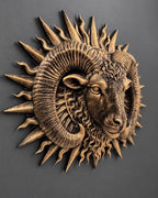 Right angle of the gold ram head showing horn ridges and sun rays