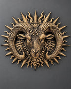 Front view of the gold Aries ram sunburst on a gray wall