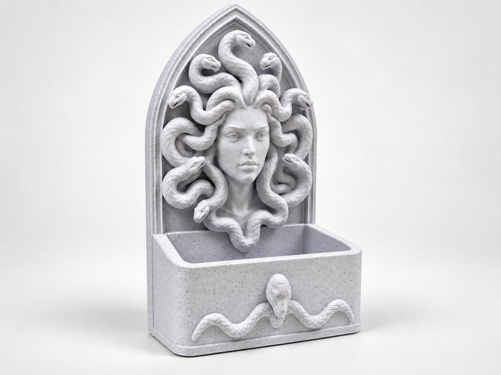 Angled view of the gothic Medusa wall organizer with an empty storage tray