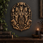 Hecate wall plaque on a dark wall above a shelf with a candle and books