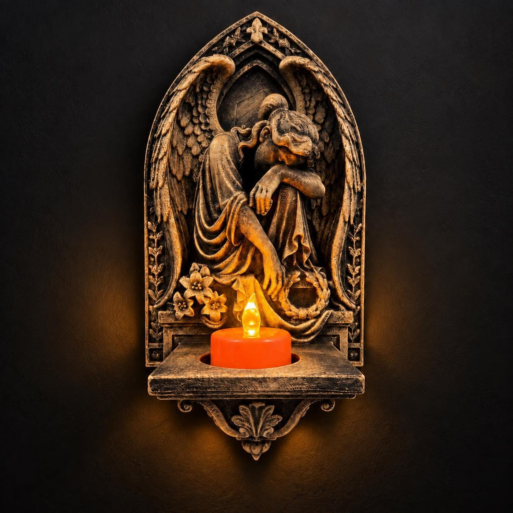 Front view of antique gold mourning angel wall sconce with a glowing LED tealight