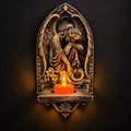 Front view of antique gold mourning angel wall sconce with a glowing LED tealight